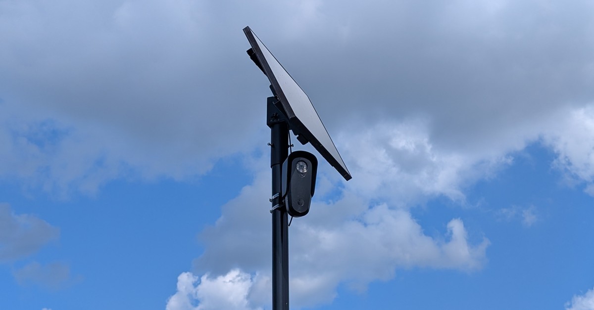 A Flock Safety license plate reader camera with solar panel mounted on a pole. Photo by MiracleMiles via Wikimedia Commons, CC BY 4.0.